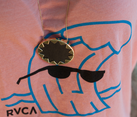 RVCA wavy coral tank and House of Harlow sunburst necklace