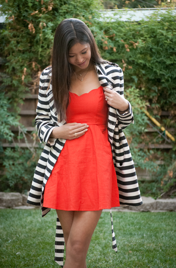orange dress with black and white striped trench