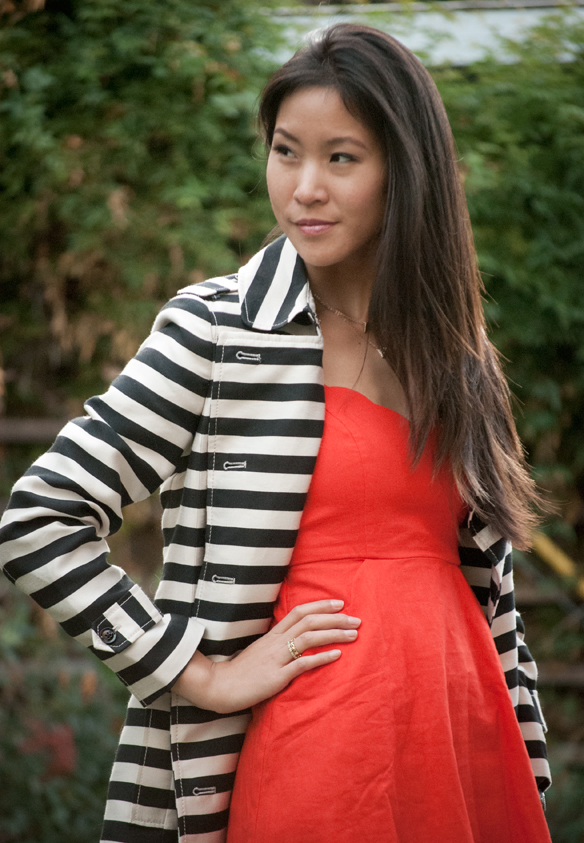 orange dress with black and white striped trench